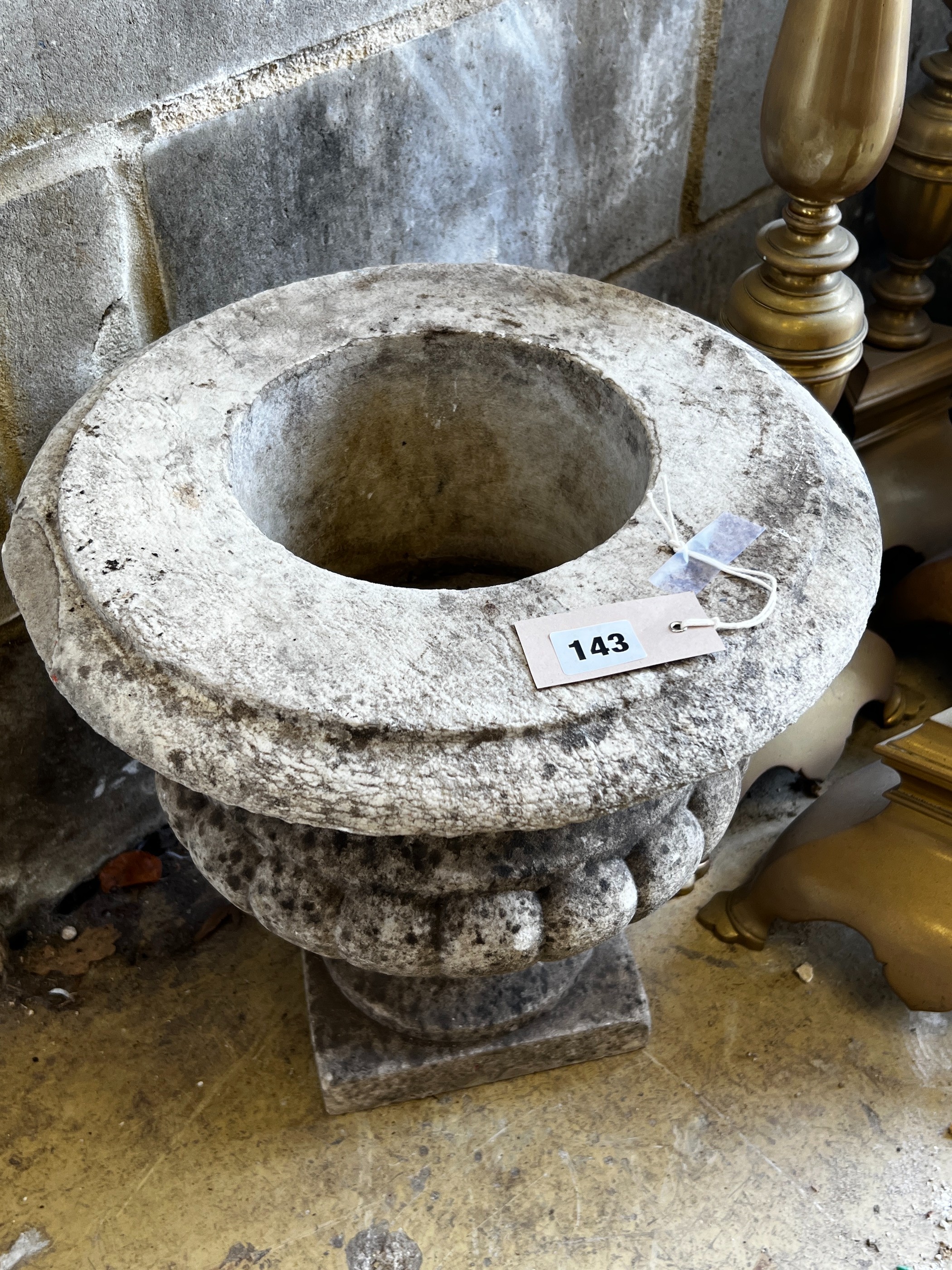 A reconstituted stone campana garden urn, diameter 36cm, height 38cm